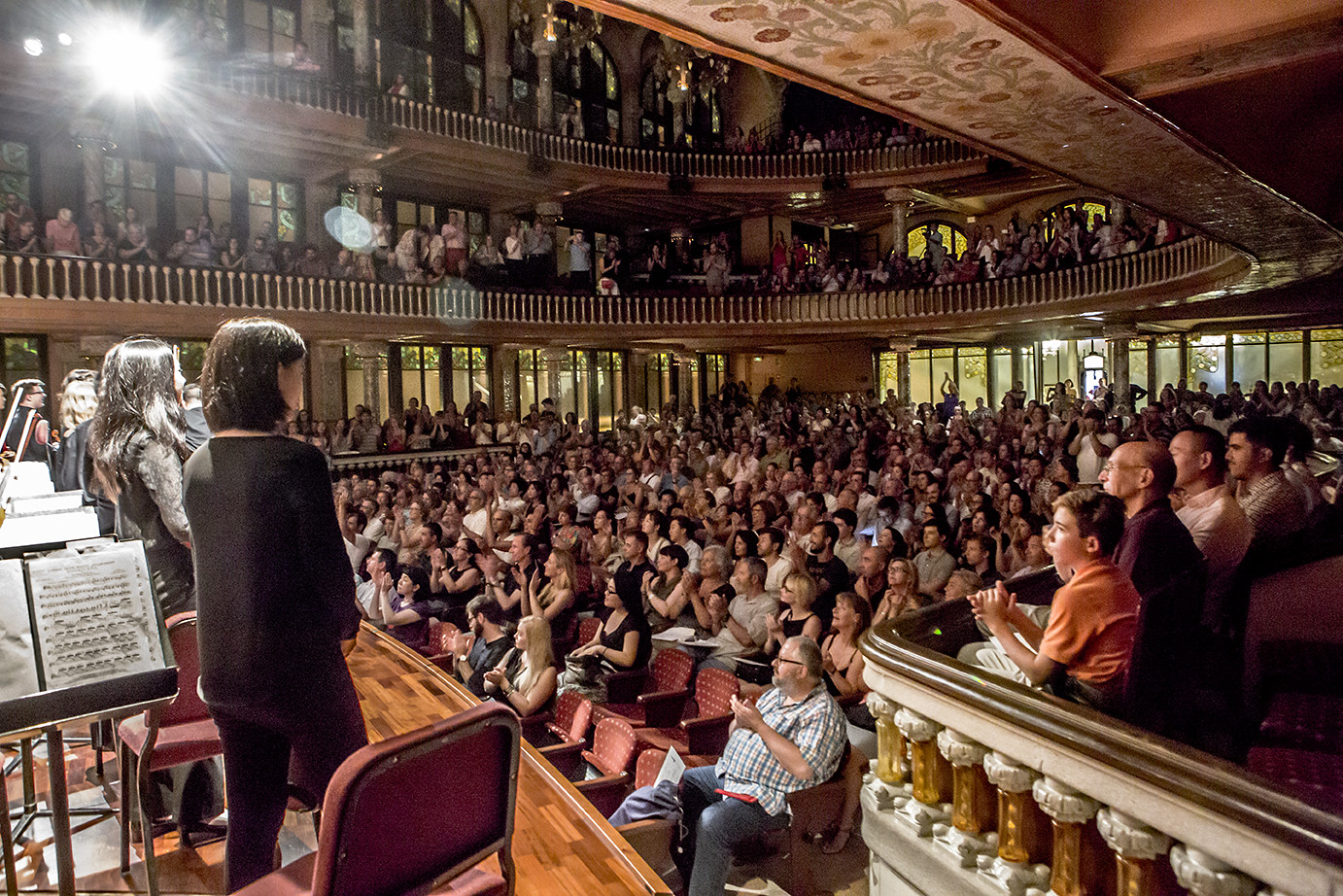 Orchestra recieving applause from full audience in the Palau in Barcelona