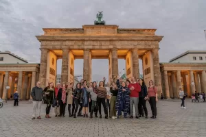 A group of people posing for a photo in front of Brandenburg Gate